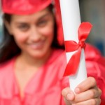 grant vs scholarship, graduate holding her diploma